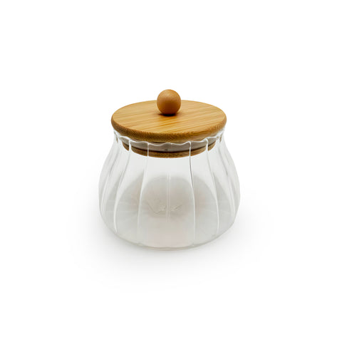 An elegant glass jar with a bamboo lid