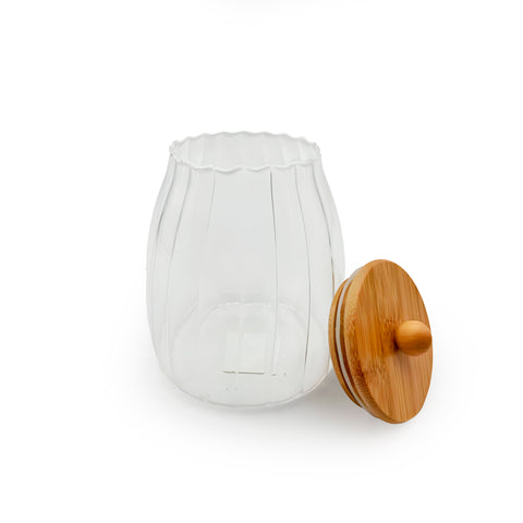 An elegant glass jar with a bamboo lid
