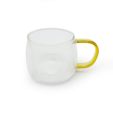 A glass cup with a fluted surface and a colored handle