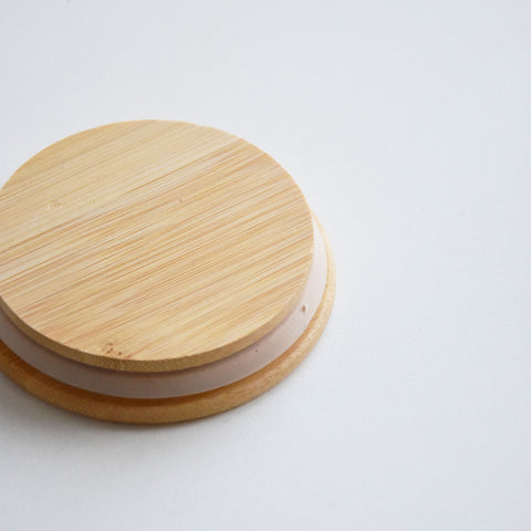 A glass jar with a bamboo lid